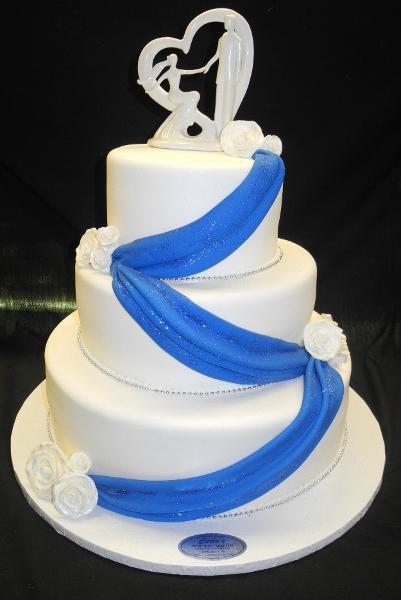 Beautiful two tiered white and blue wedding cake decorated with flowers  sugar roses. Concept of elegant holiday desserts Stock Photo | Adobe Stock