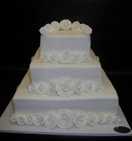 A wedding cake with white roses - Stock Photo - Dissolve