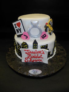 New York City Fondant Engagement Cake with edible fondant ring, taxi, and building cut outs