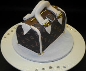 Louis Vuitton Hand Bag Sitting On Louis Vuitton Box Cake